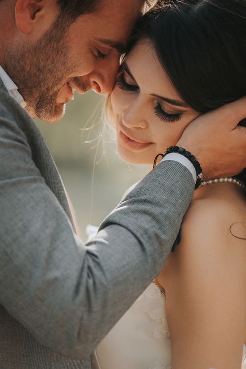 Free A tender moment between a newlywed couple sharing an embrace on their wedding day. Stock Photo