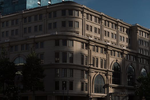 Neoclassical building facade in cityscape under soft daylight.