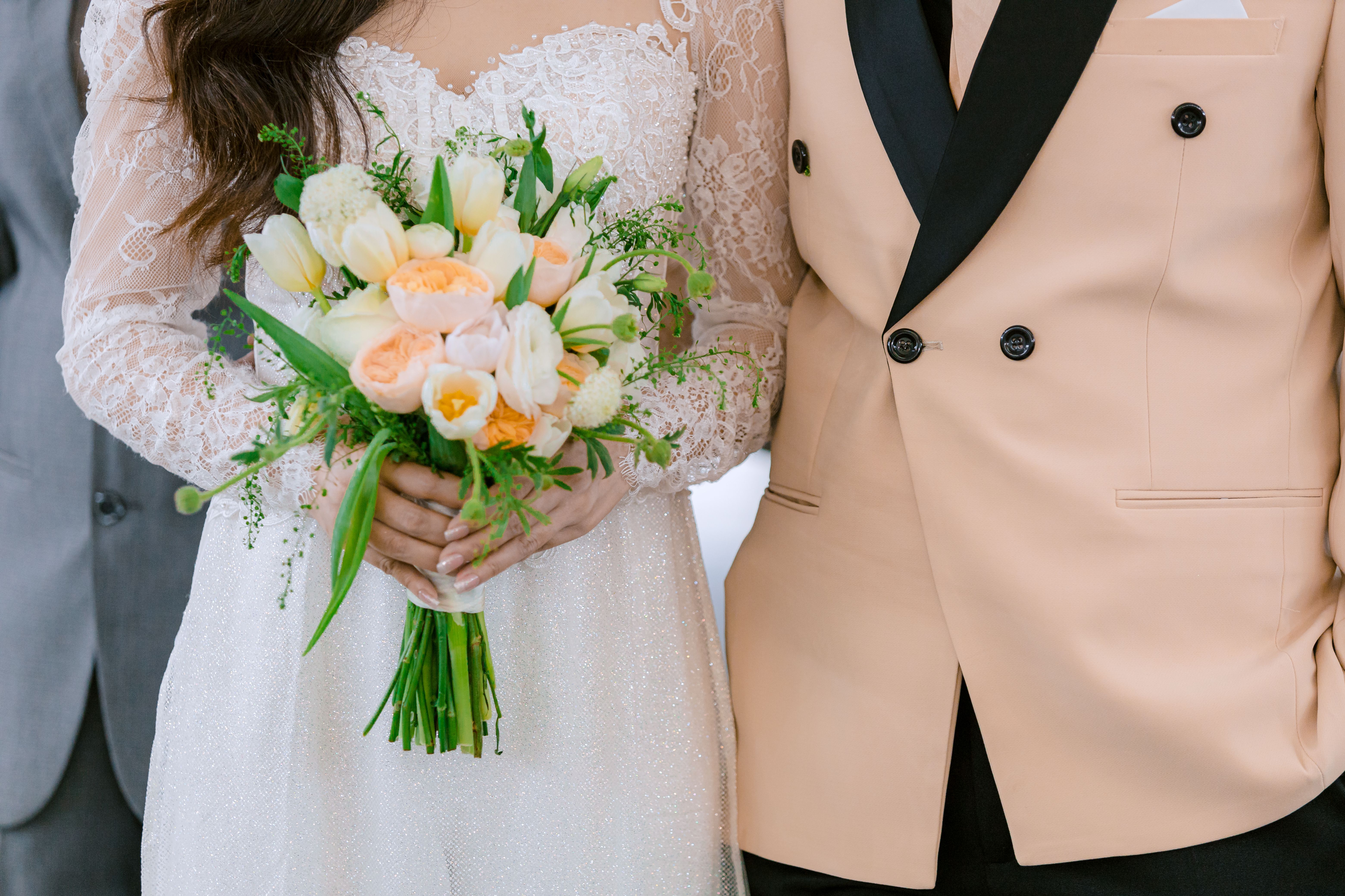 A Bride in White Wedding Gown Holding a Bouquet of Flowers · Free Stock ...