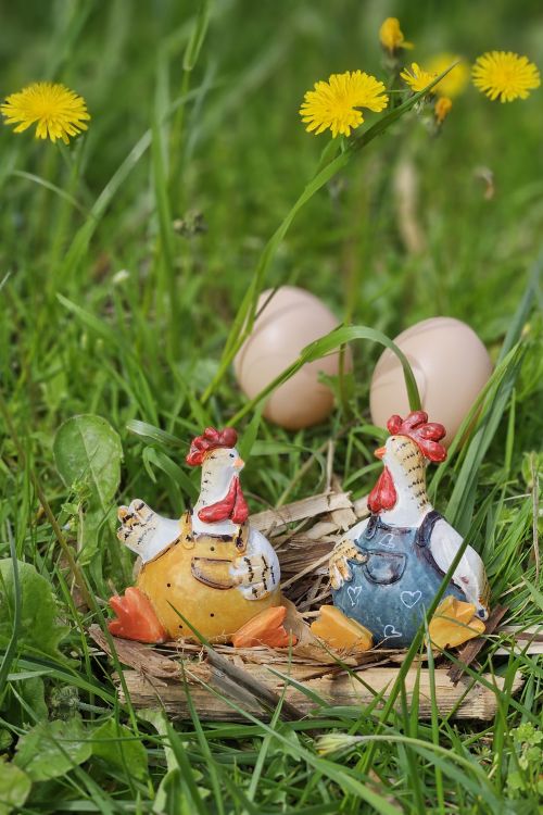 Free Festive Easter scene with decorative hens and eggs in lush green grass. Stock Photo