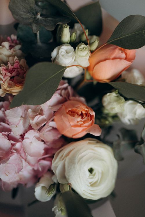 Free A stunning close-up of a floral bouquet featuring roses, ranunculus, and hydrangeas. Stock Photo