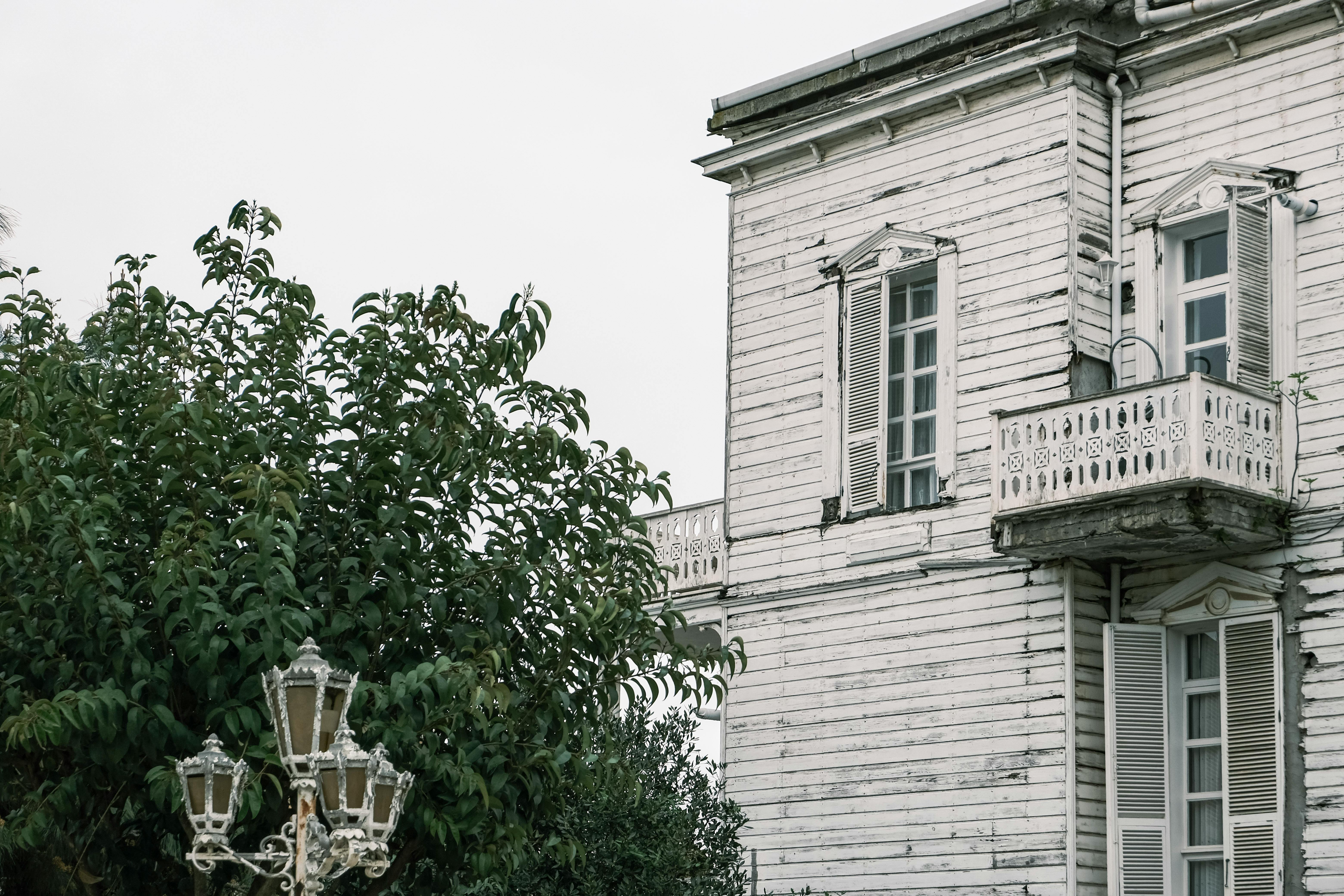 Historic timbered house with classic architecture, surrounded by lush greenery in Istanbul.