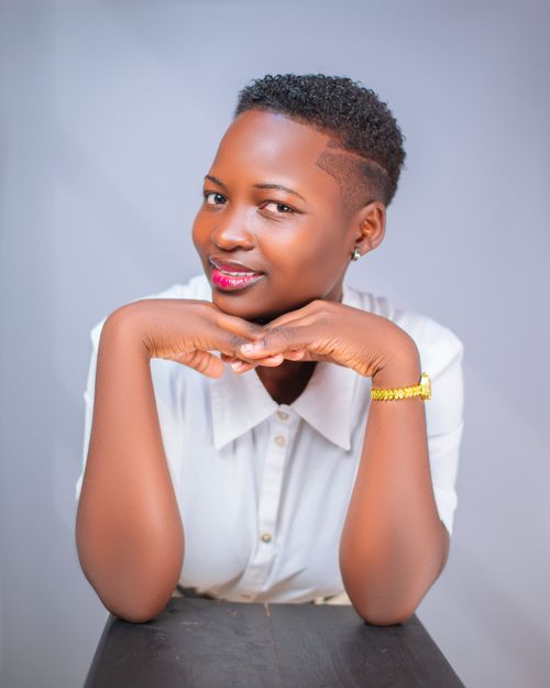 Free Portrait of a smiling woman in white shirt in a studio setting, Bungoma. Stock Photo