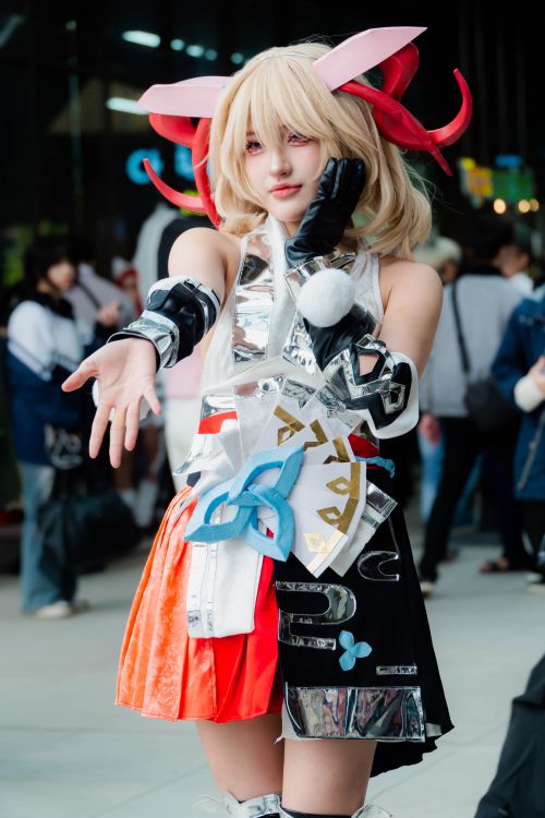 Free Cosplayer in an intricate and colorful anime-inspired costume posing for photos at a convention. Stock Photo