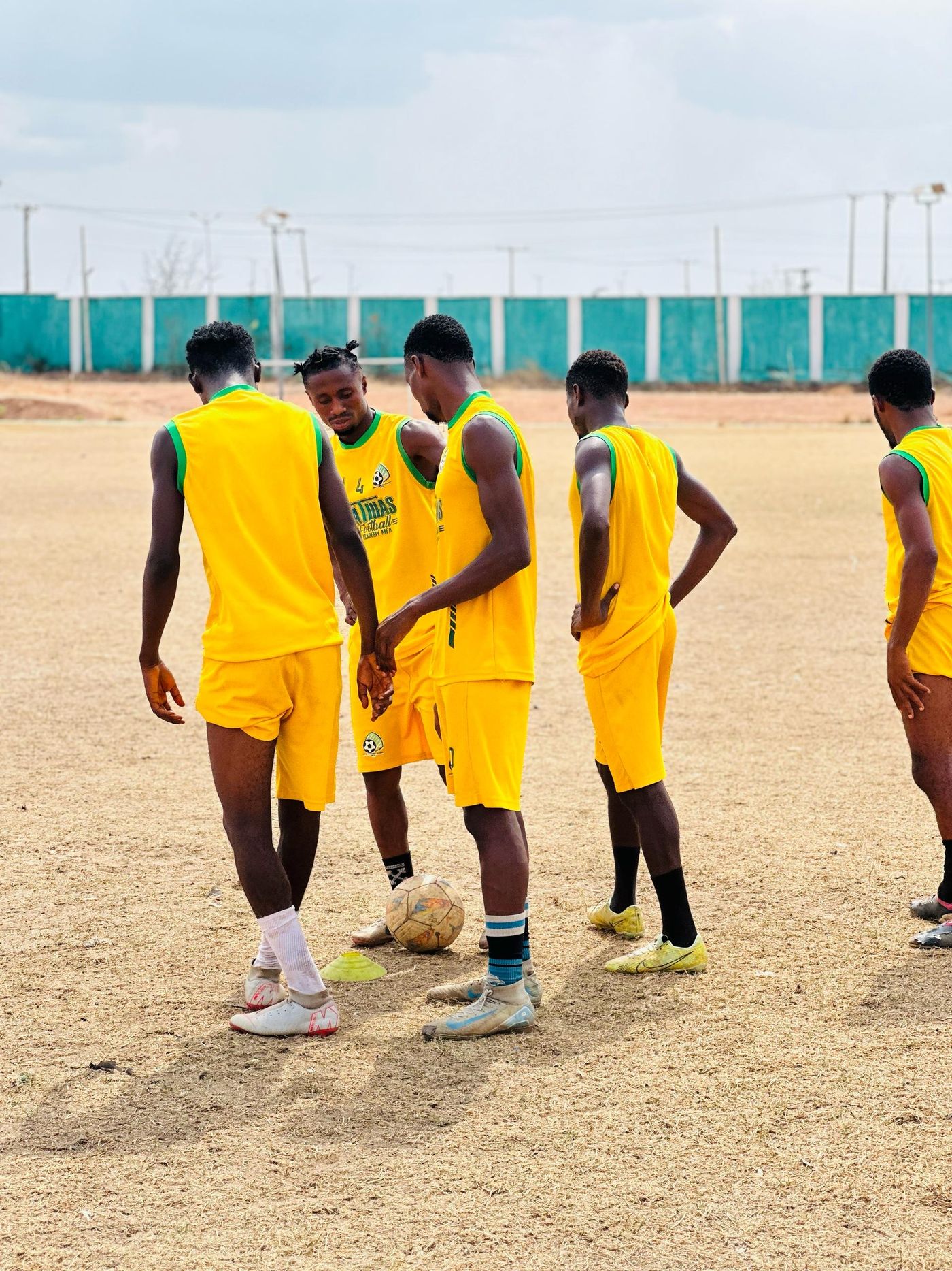Young soccer players participating in team training