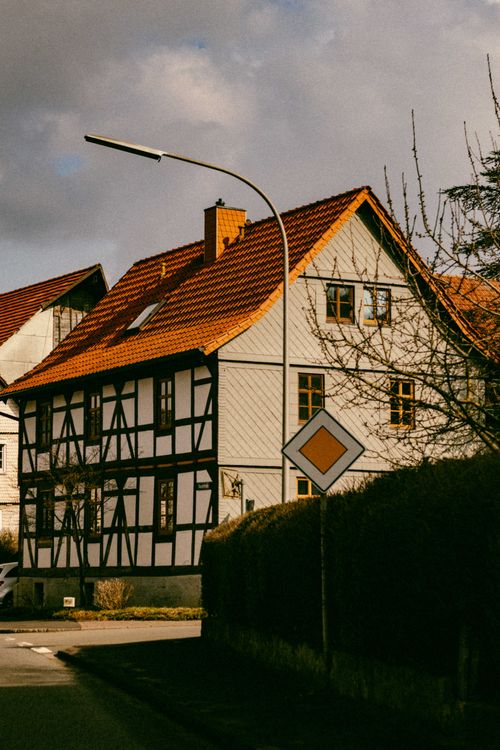 Free Half-timbered house with red roof under golden hour light. Stock Photo