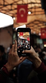 Capturing the bustling street market in Gaziantep through a smartphone lens, vibrant and lively.