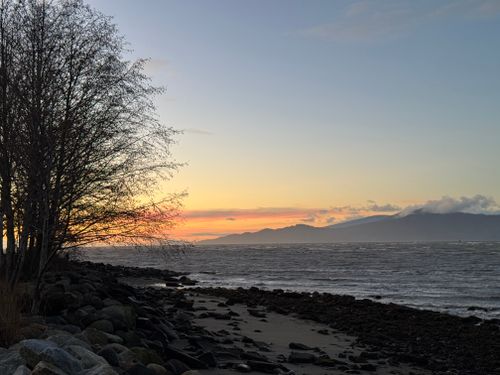 Free Stunning sunset view over the beach and mountains in Vancouver, Canada. Stock Photo