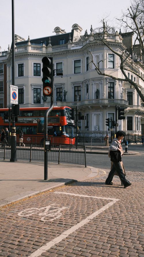 Free Urban scene featuring red double-decker bus on a sunny day in London with classic architecture. Stock Photo