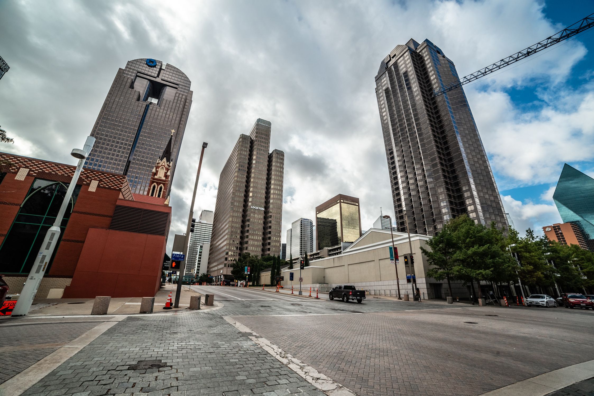 Explore the modern skyline of downtown Dallas, Texas with towering skyscrapers under a dramatic sky.