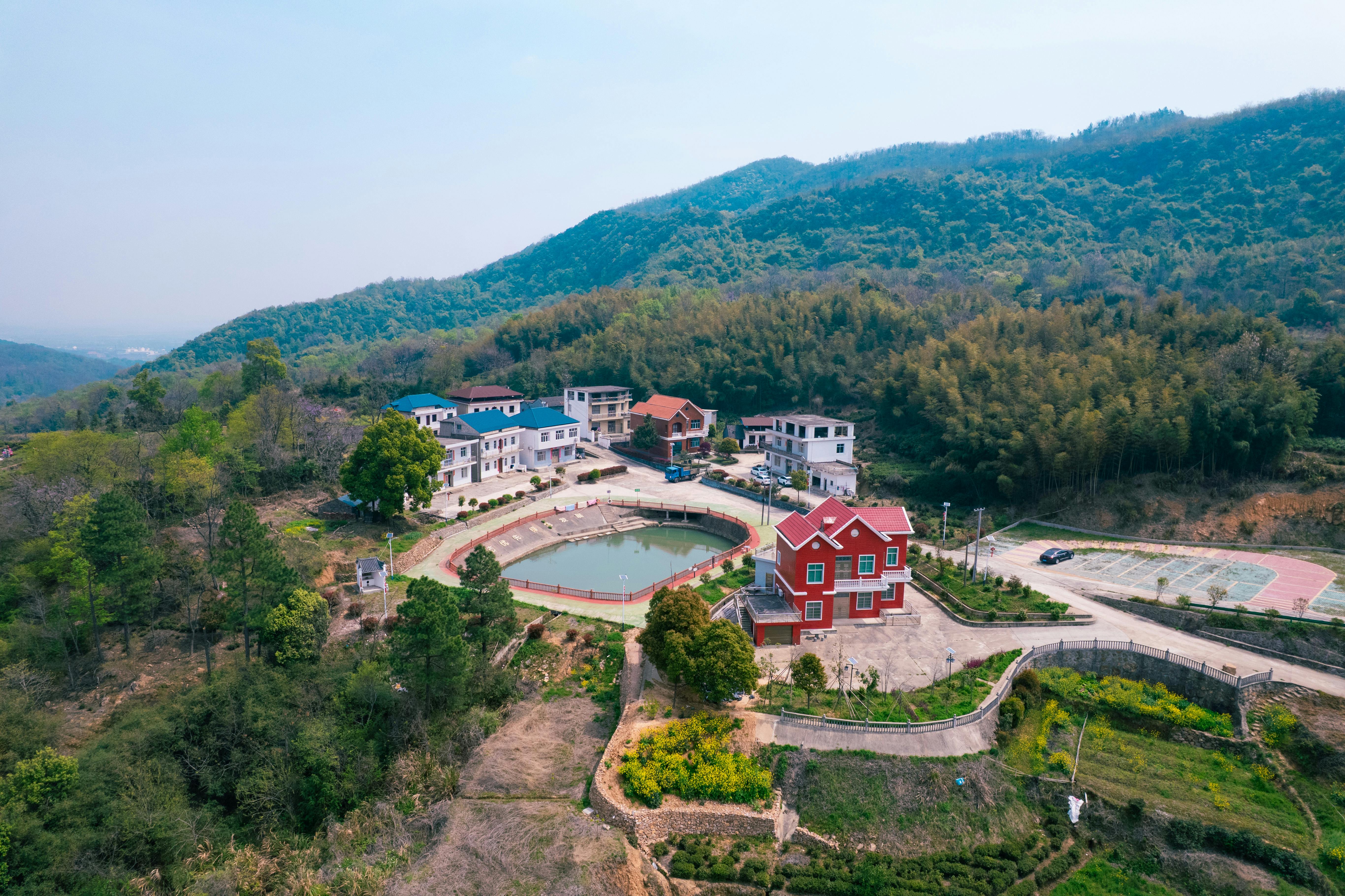 Aerial view of Ho township with green hills and community gathering spots