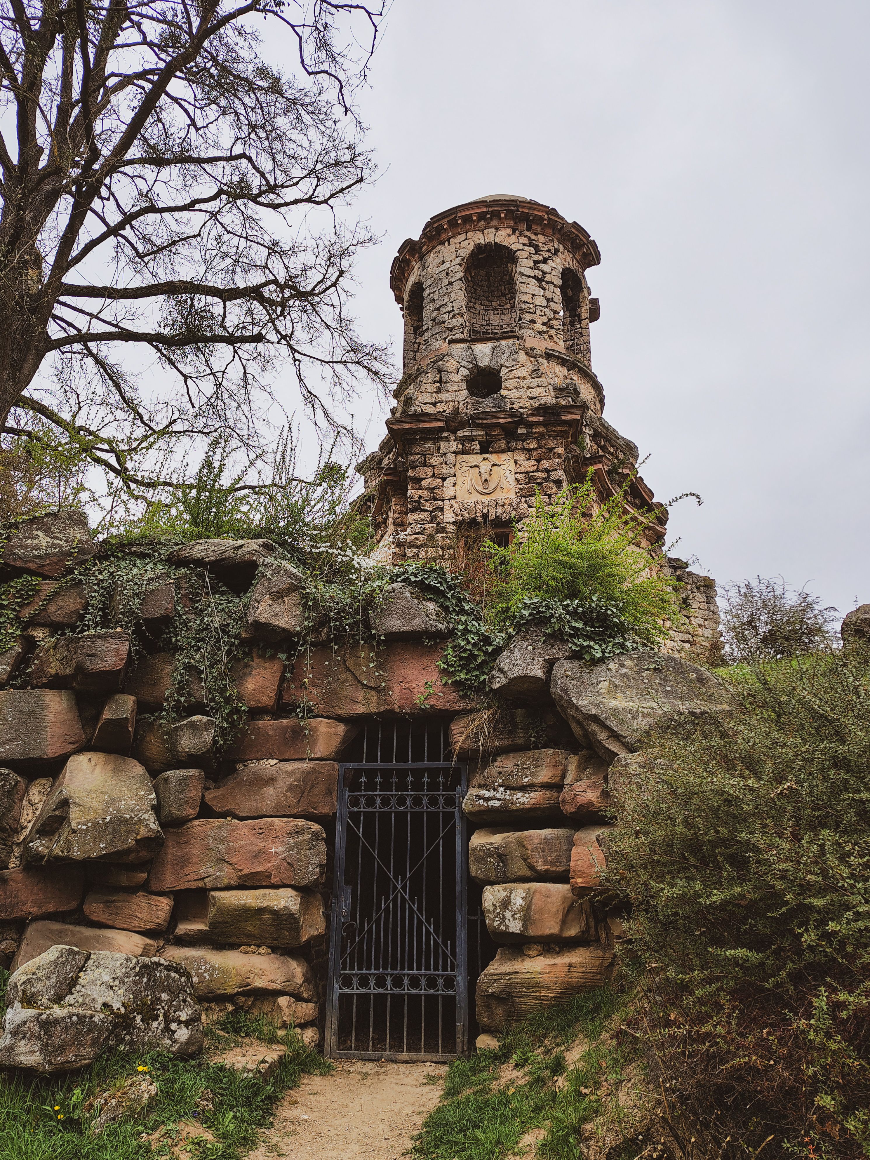 Ancient Stone Tower in a Lush Garden Setting · Free Stock Photo