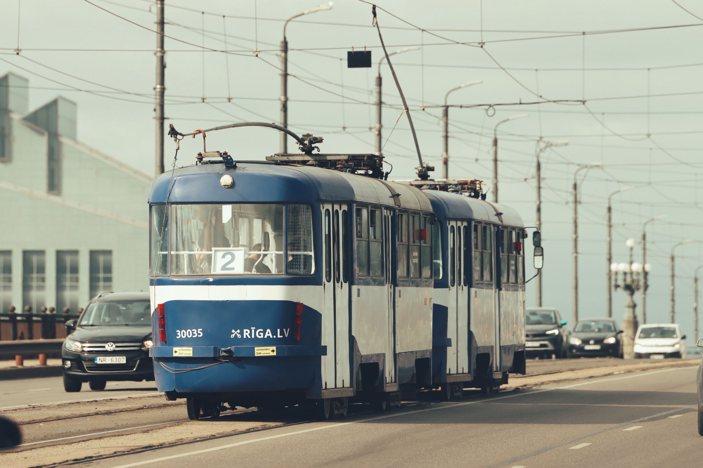 Smartrans Riga Riga Tram on City Street with Cars in View · Free Stock Photo