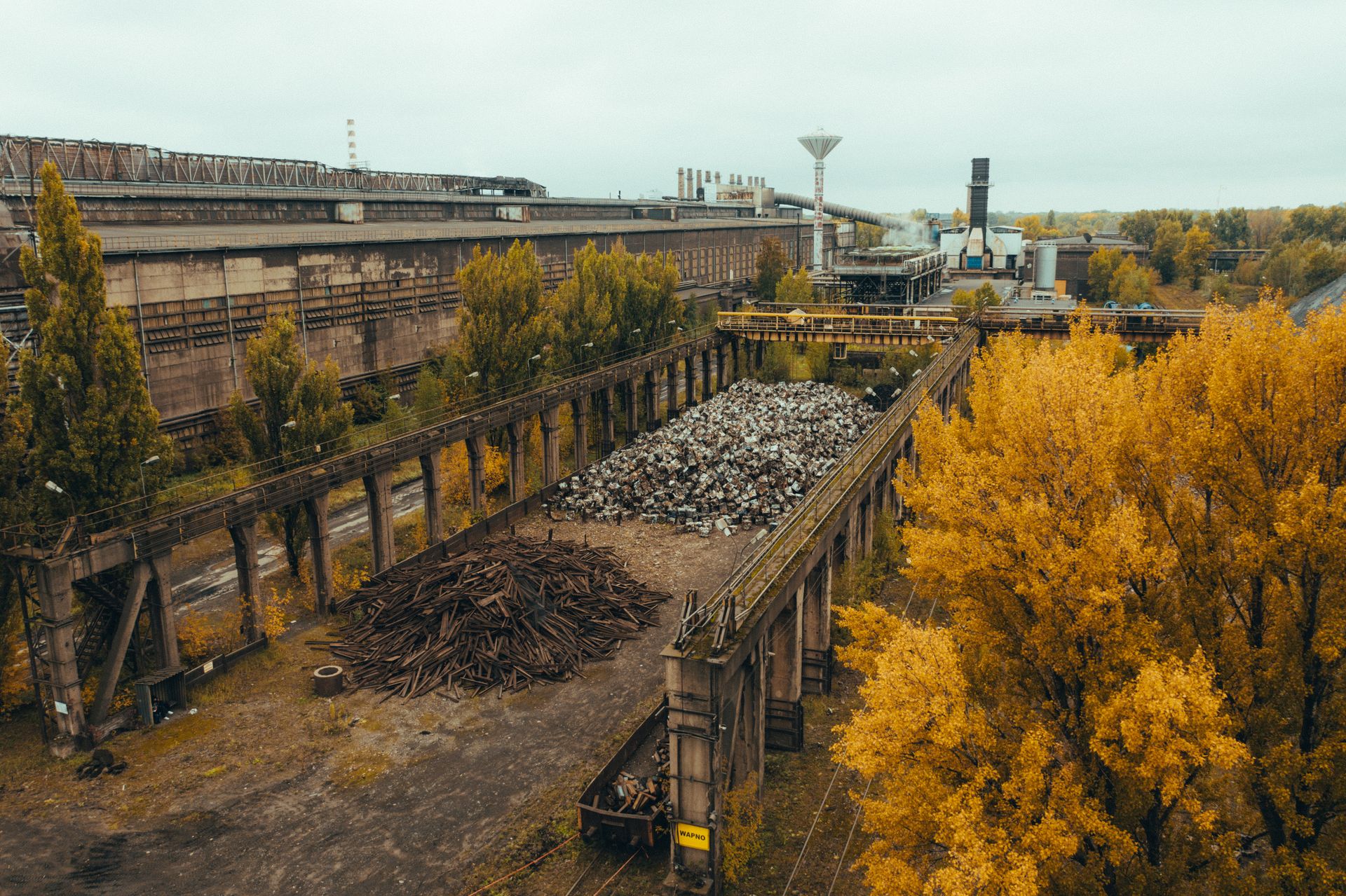 Aerial shot of old ironworks surrounded by autumn trees in Warszawa, Poland.