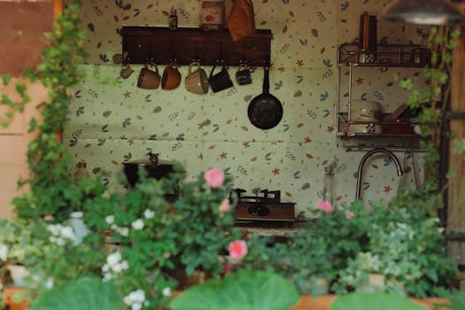 Charming view of a rustic kitchen through lush greenery, evoking homely warmth.