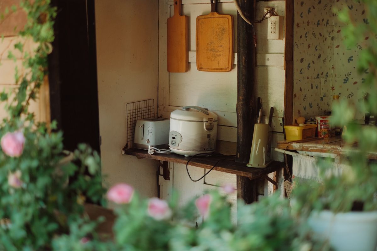 Cozy rustic kitchen counter with home cookware and kettle
