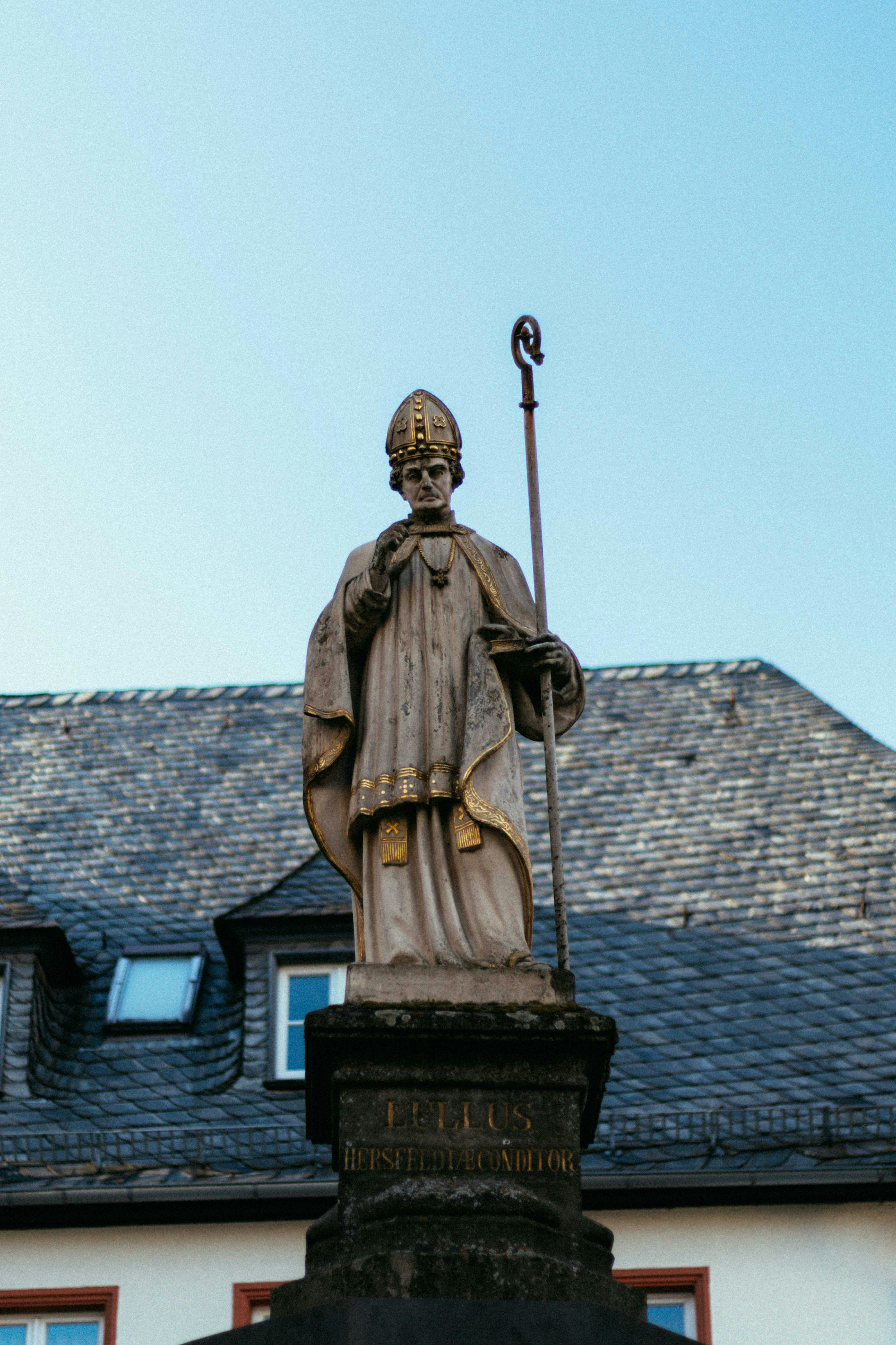 Stone statue of a saint in Bad Hersfeld, Germany, highlighting historic and cultural elegance.