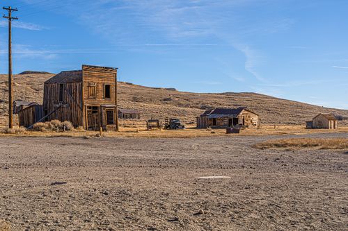 Free Explore this historic ghost town in Bridgeport, California with abandoned wooden buildings under a clear blue sky. Stock Photo