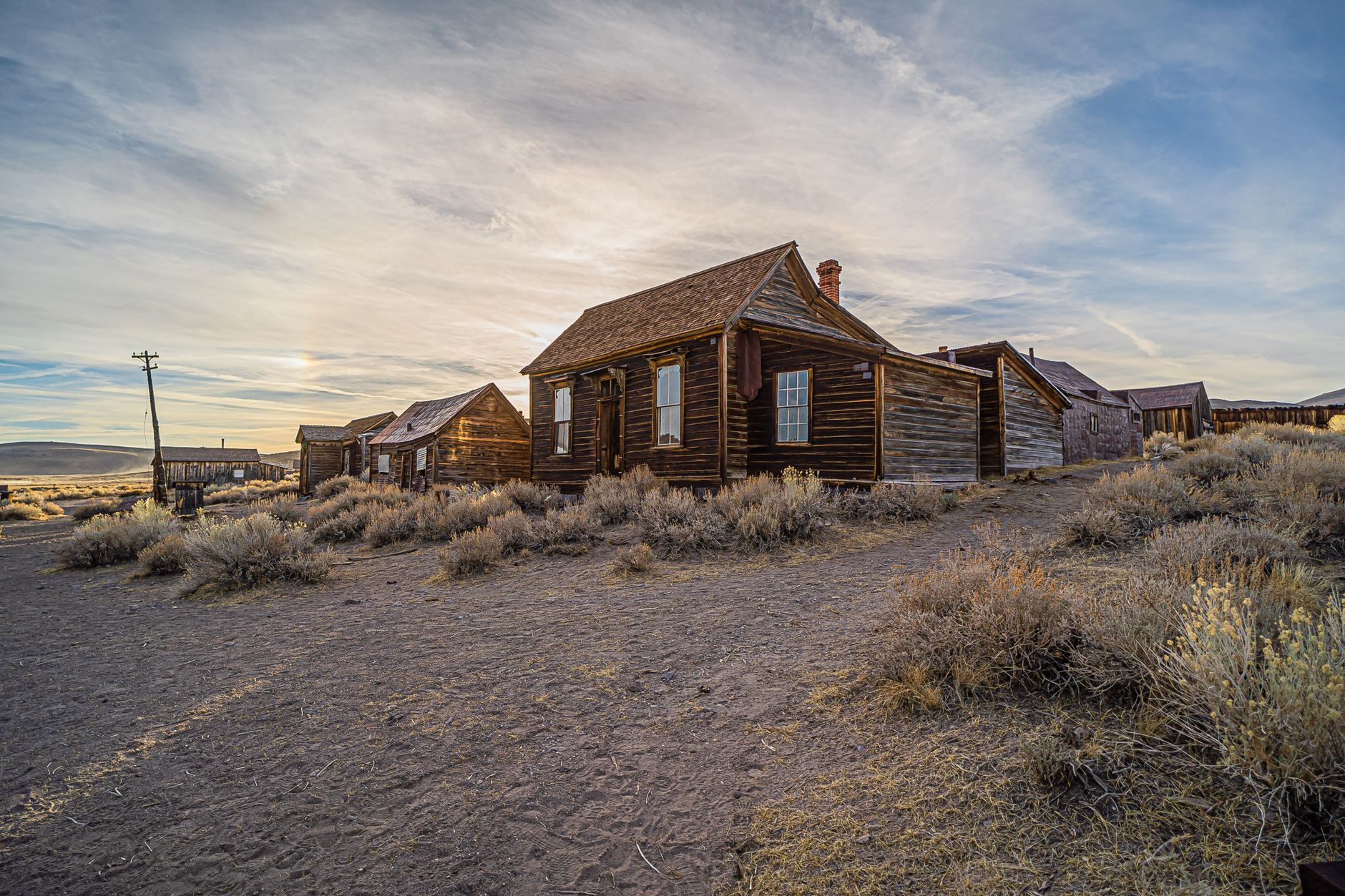 Explore the picturesque Bodie ghost town in California during a stunning sunset.