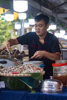 A vibrant scene of a street vendor cooking a traditional Vietnamese snail dish in Hồ Chí Minh City.