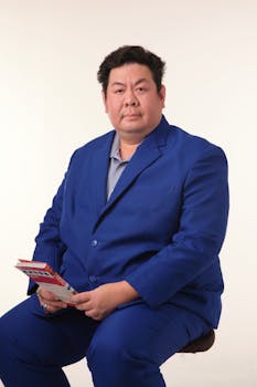 Confident man wearing a vibrant blue suit, holding a document. Ideal for business concepts.