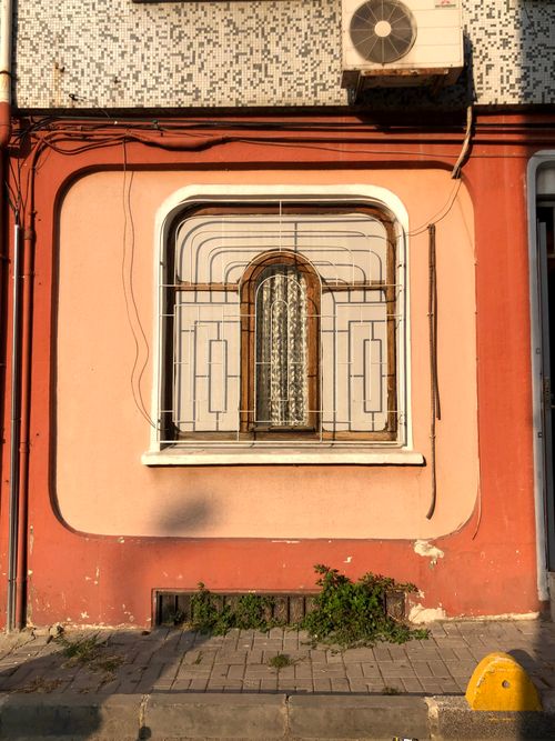 Free A beautifully framed window with intricate grillwork on a colorful wall in Istanbul, Turkey. Stock Photo