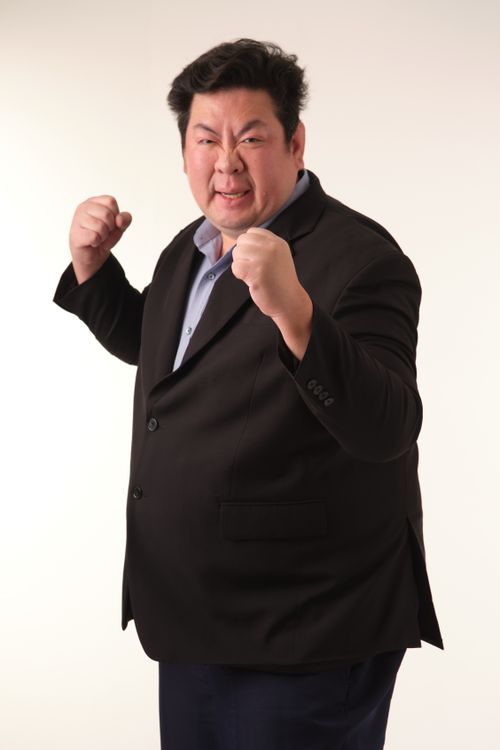 Free Portrait of a determined businessman in a fighting stance against a plain background. Stock Photo