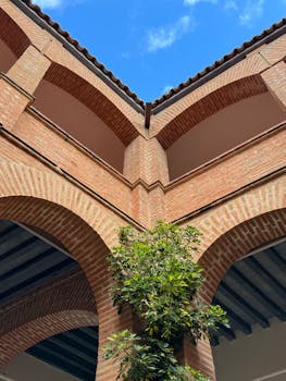 Stunning view of historic brick arches and vibrant vegetation in Badajoz, Spain.