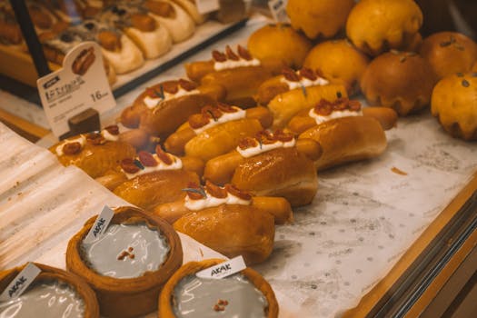 A display of fresh breads and pastries in a bakery setting, highlighting variety and texture.