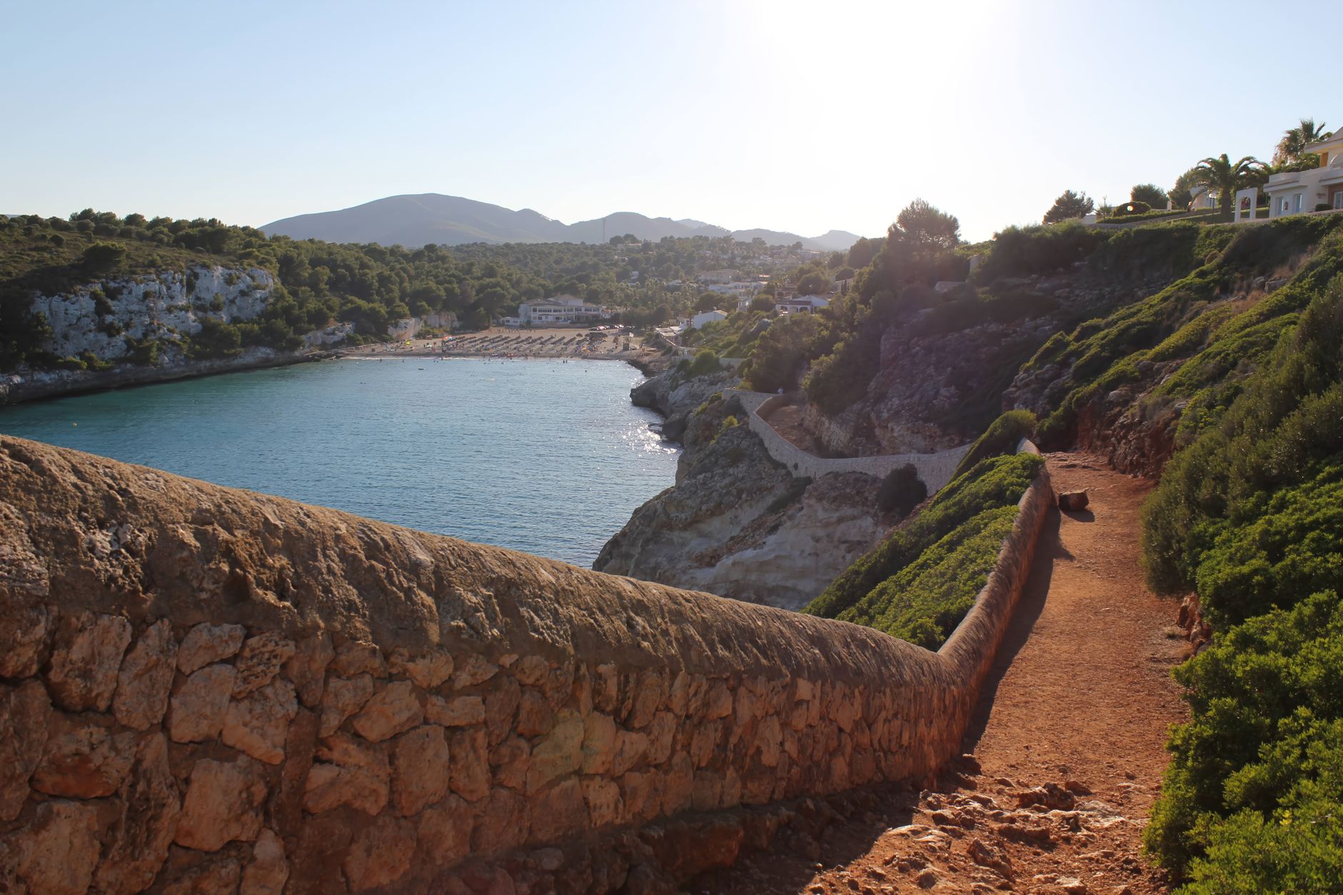 Breathtaking view of Cala Romantica's beach and coastline path in the Balearic Islands, Spain.