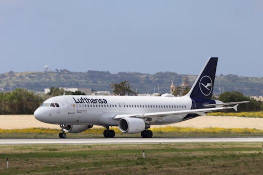 Lufthansa Airbus A320 jet preparing for takeoff on a sunny day.
