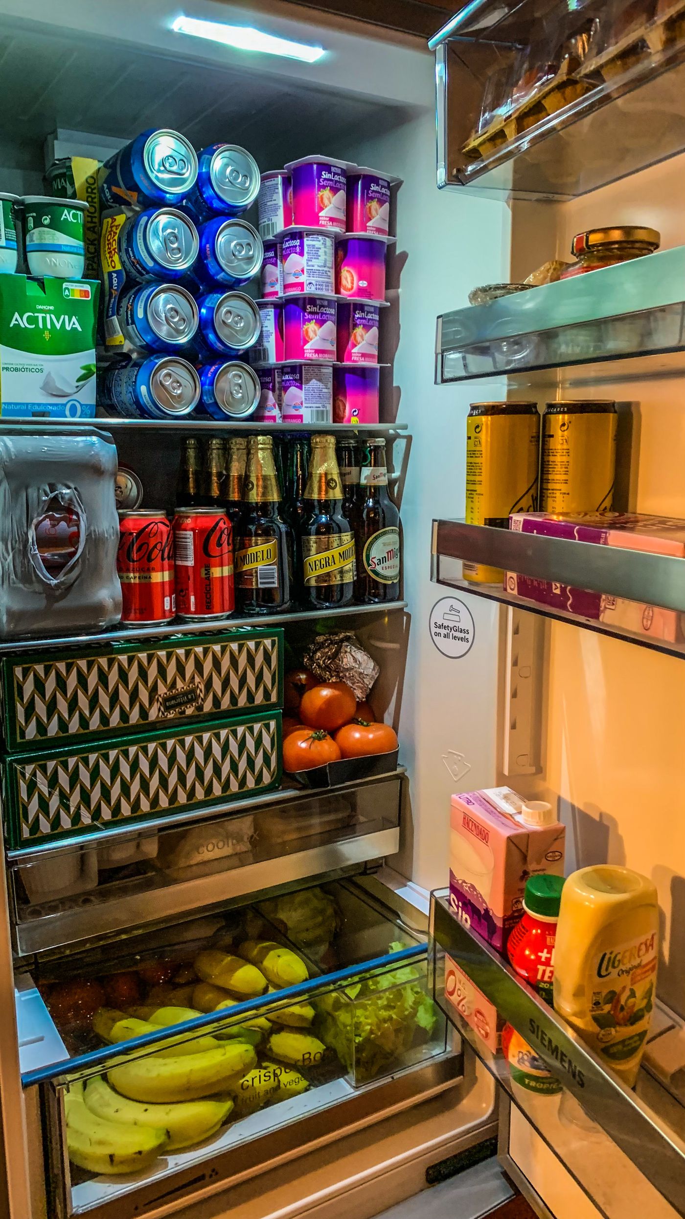 Open refrigerator with organized groceries and food containers