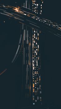 Dramatic aerial shot of a bustling highway with light trails, captured at night.