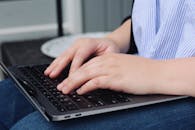 Woman Typing on Laptop in Outdoor Workspace