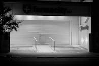 Closed Pharmacy with Metal Shutters at Night