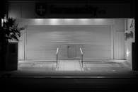 Closed Pharmacy with Metal Shutter at Night