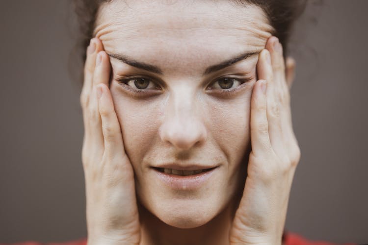 Selective Focus Portrait Photo Of Woman Stretching Face