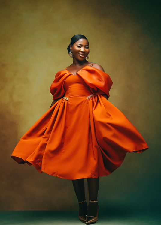 Elegant Woman in Vibrant Orange Dress  Free Stock Photo