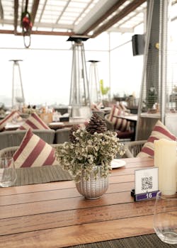 Chic indoor restaurant setting with floral centerpiece and cozy ambiance. Ideal for dining themes.