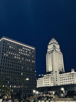 Dramatic night view of the iconic Los Angeles City Hall building.