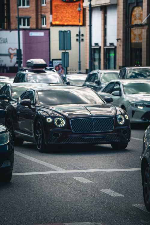 Free A luxury Bentley navigating through busy Kyiv traffic showcasing urban life. Stock Photo
