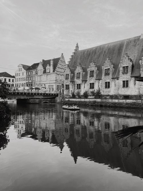 Free Scenic view of historical buildings and canal in Ghent, Belgium, in moody black and white. Stock Photo