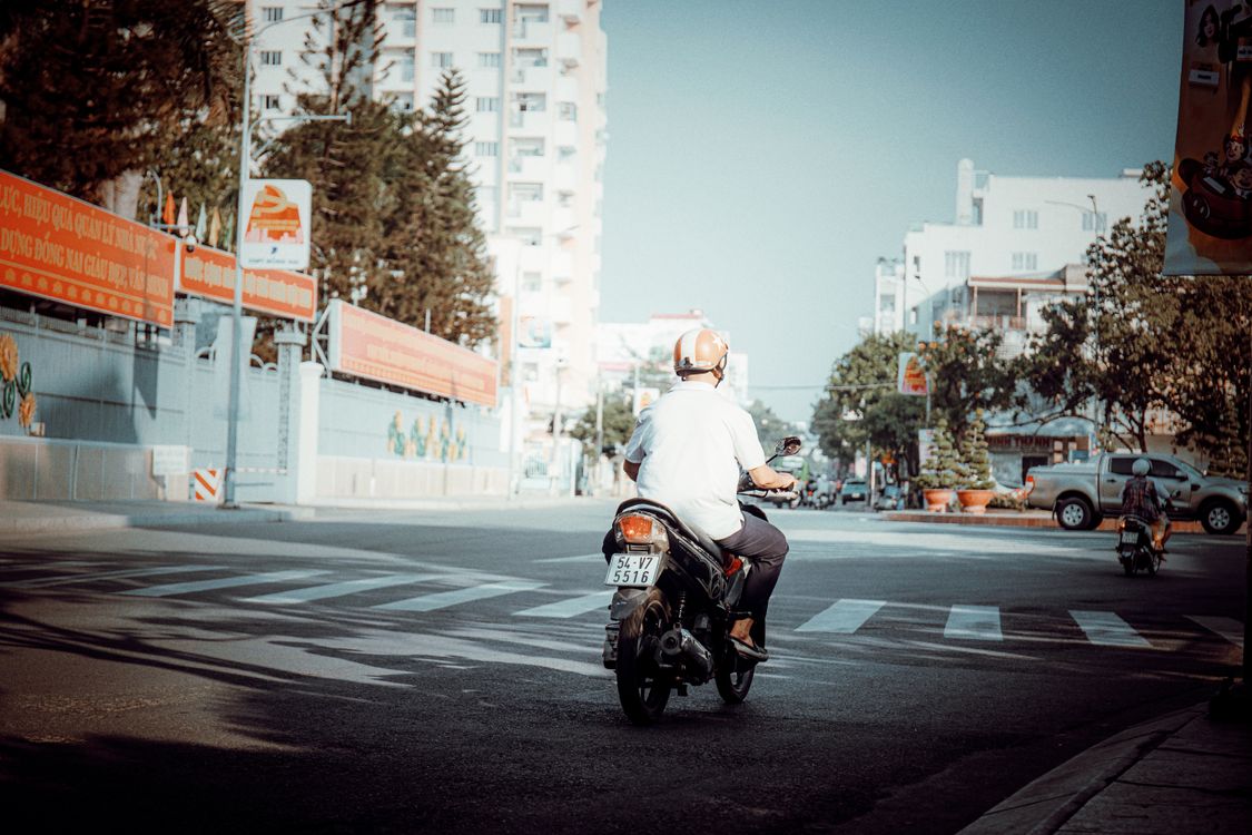 Street Riding Motorcycle Motorcyclist Riding Through Urban Crosswalk · Free Stock Photo