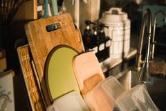 A well-organized kitchen sink area featuring cutting boards and storage containers in a cozy setting.