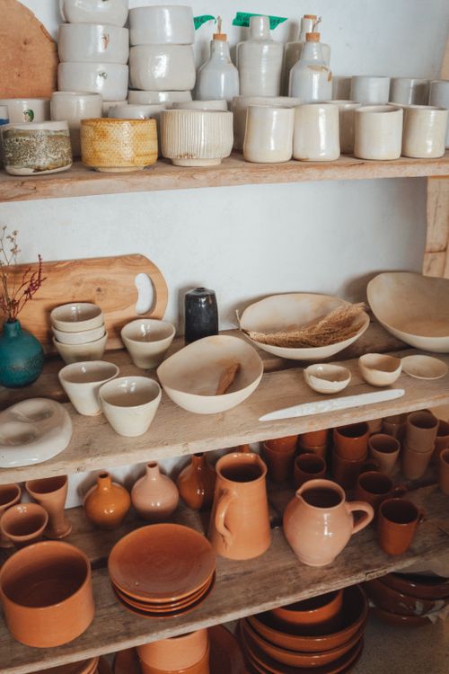Free Cozy rustic shelves displaying various ceramics and decor items, perfect for a vintage kitchen aesthetic. Stock Photo