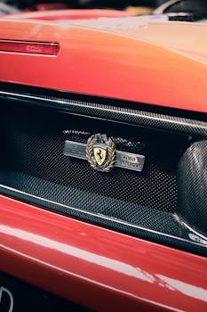 Detailed shot of the iconic Ferrari rear badge, showcasing luxury sports car design.