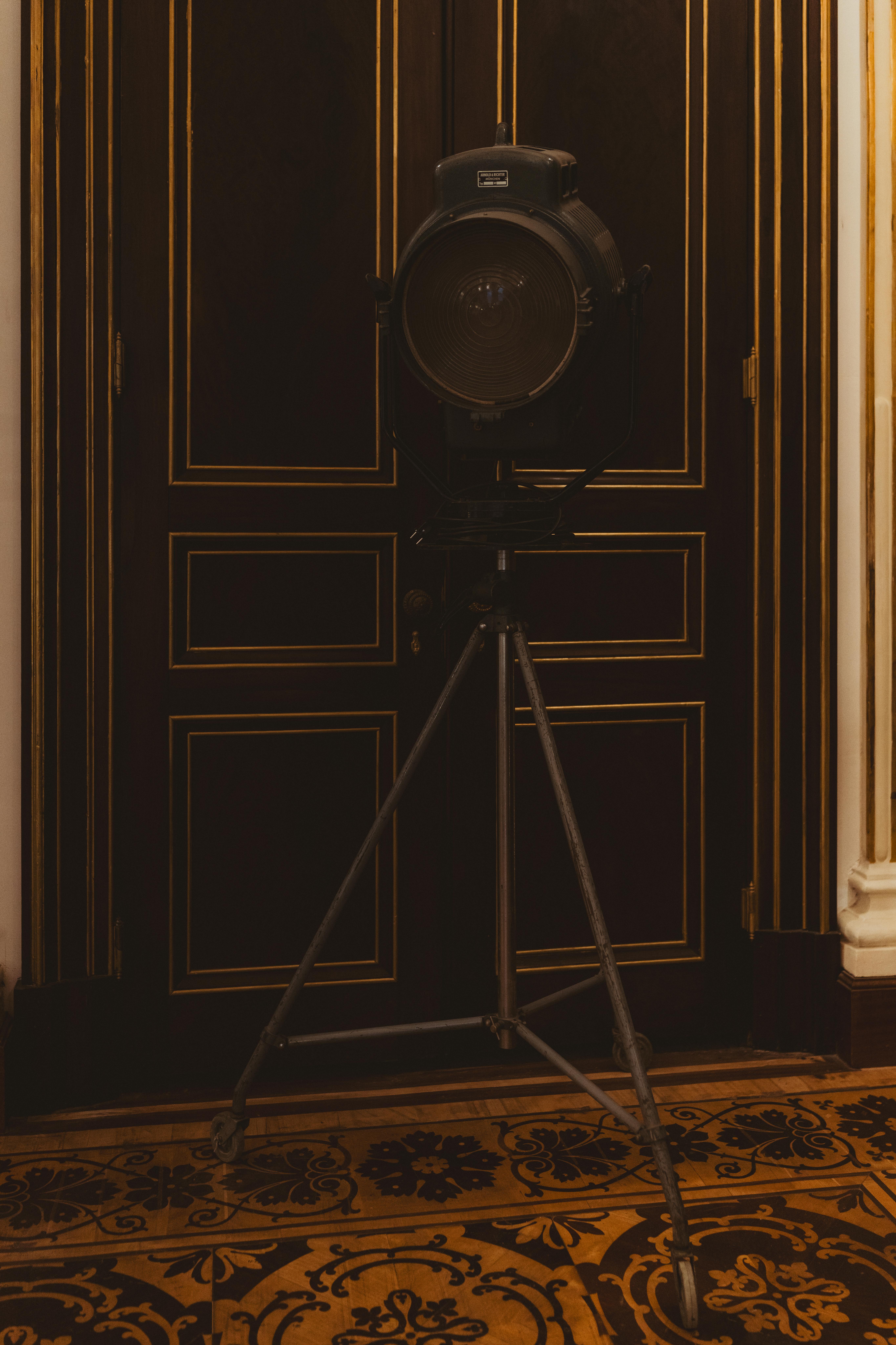 Free A classic vintage spotlight stands on a decorative floor in a sophisticated interior. Stock Photo