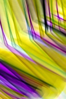 Dynamic abstract art with vibrant yellow and purple motion blur, creating a lively visual effect.
