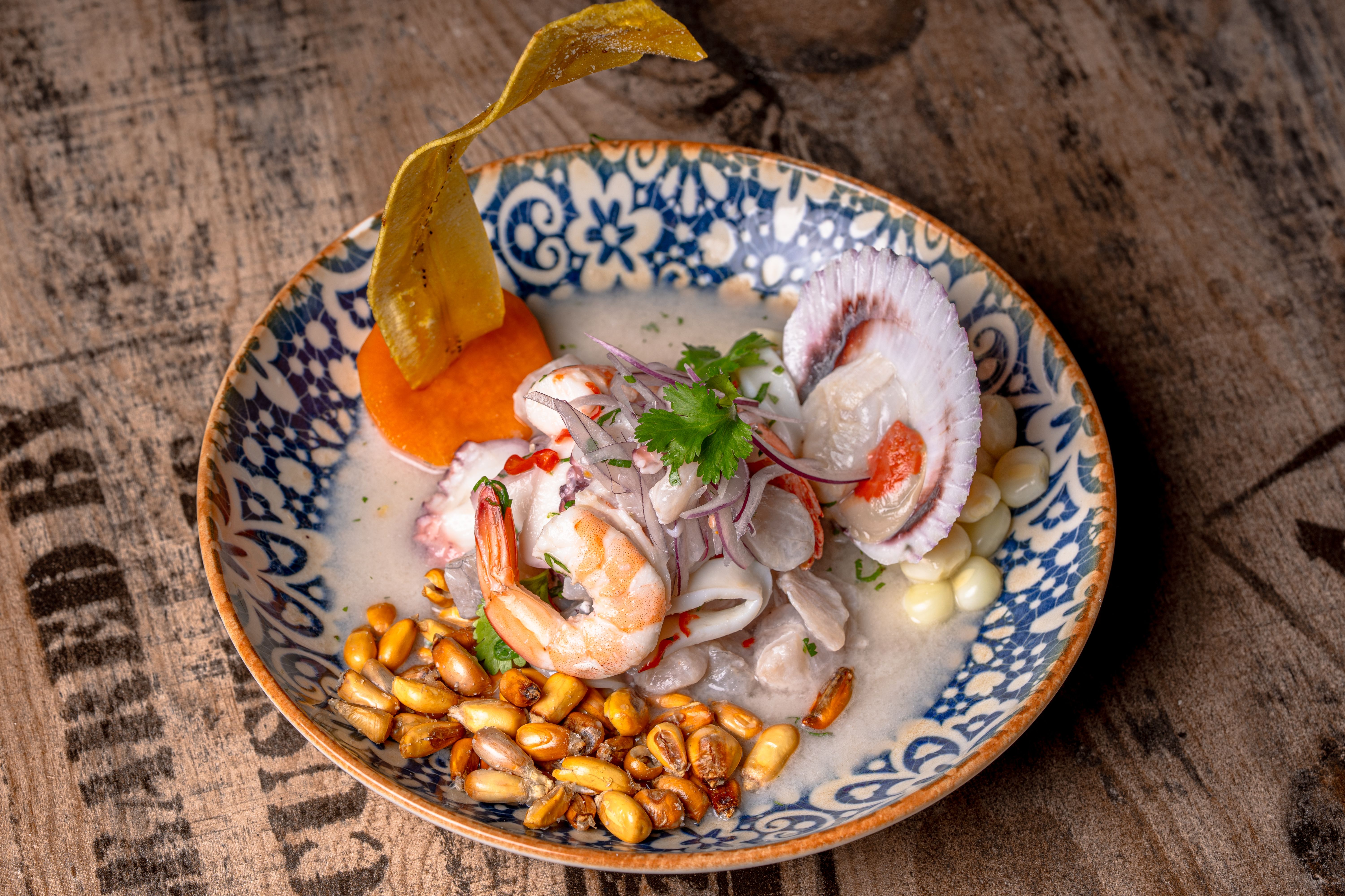 Fresh ceviche with shrimp, citrus, and garnish on a plate