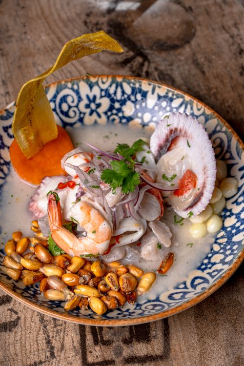 Free Authentic Peruvian seafood ceviche with shrimp, scallops, corn, and cilantro in a decorative bowl. Stock Photo